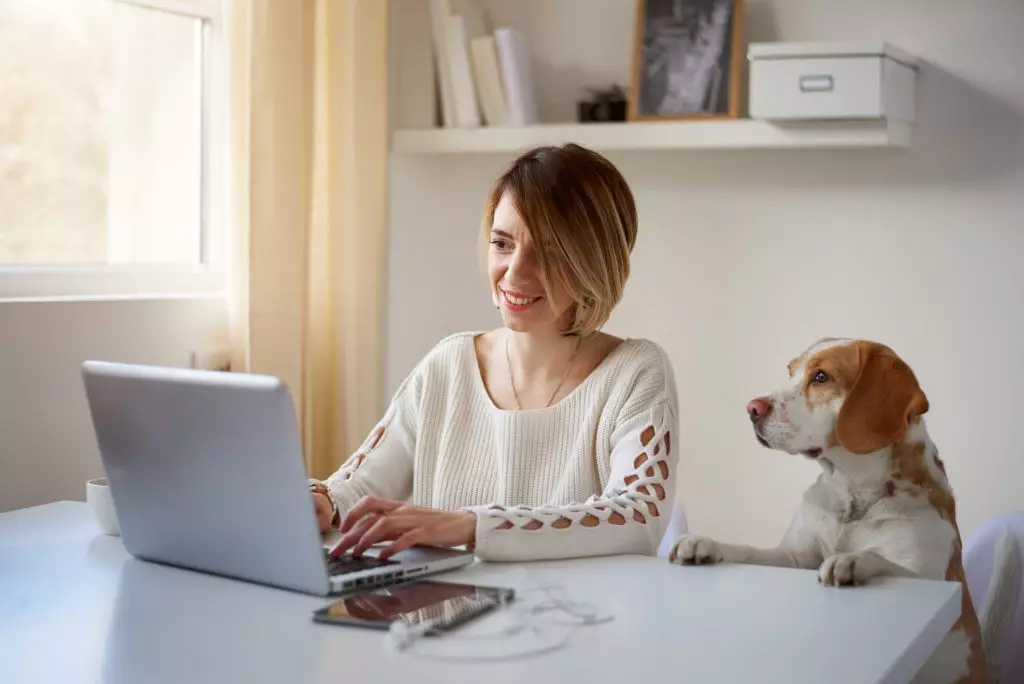 Remote worker in home office interacting with company employees.